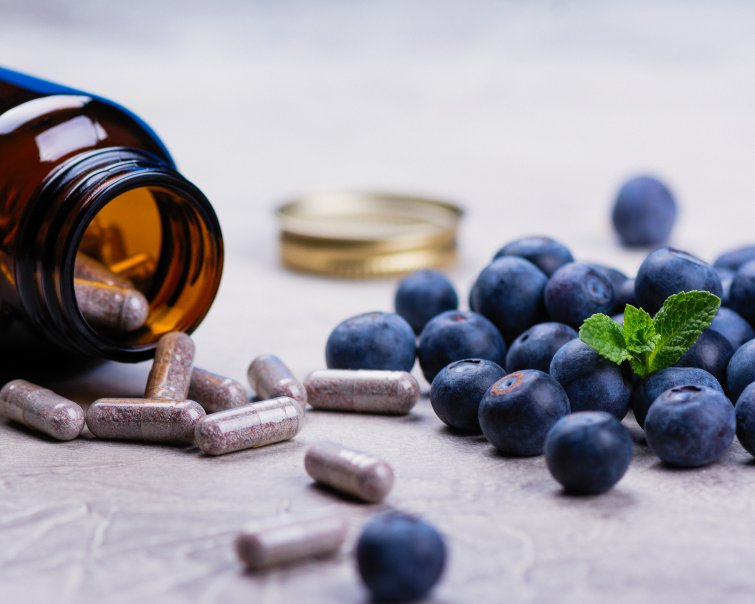 vitamins and blueberries on white background